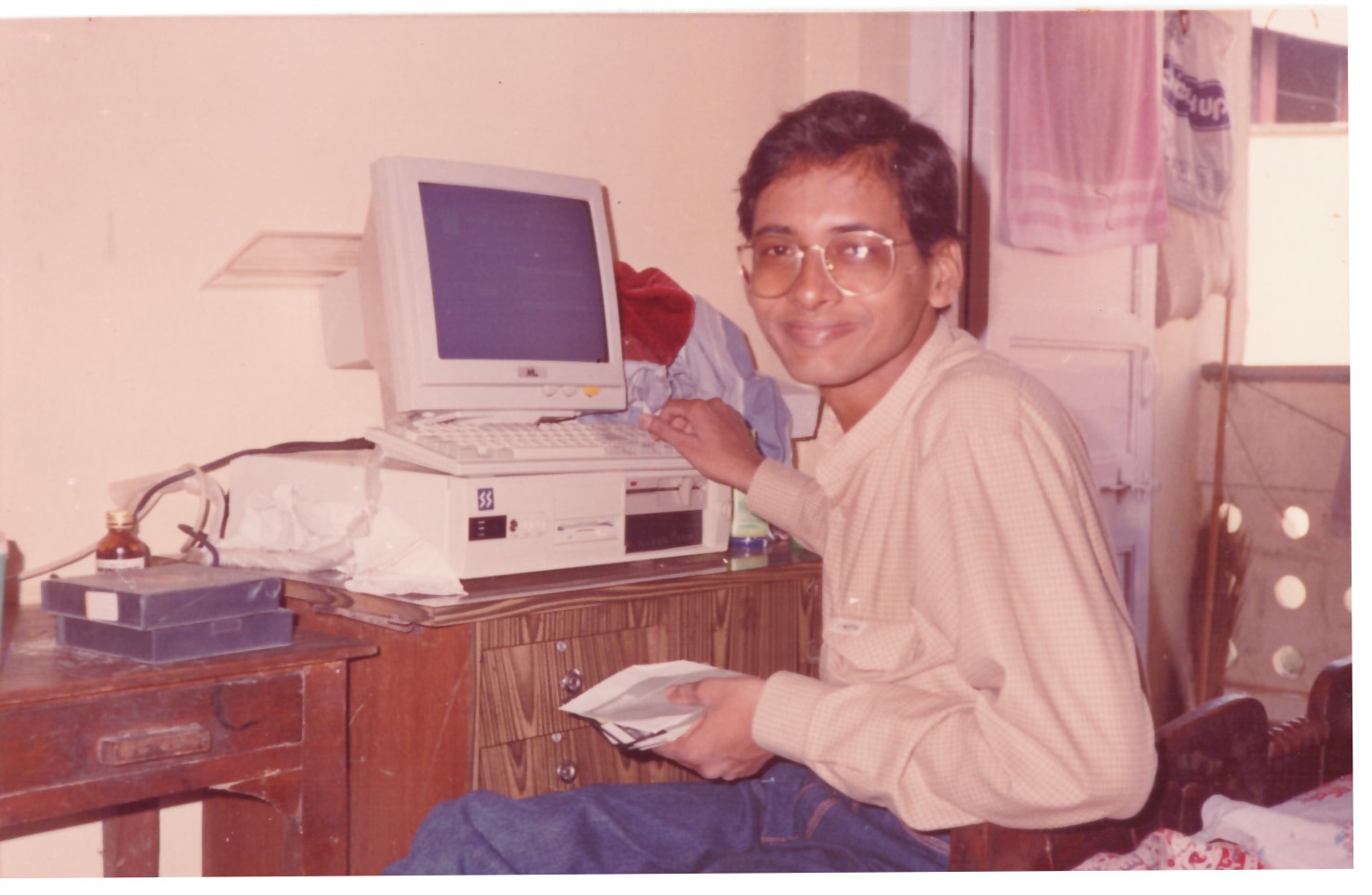 Sampath K Iyengar with his first desktop computer in the 1990s — the balcony workspace where SAM7 began.